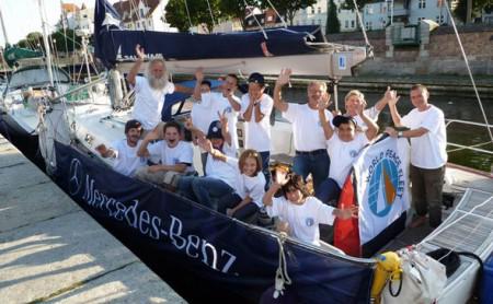 Glückliche Kinder, die auf einer Segelyacht Kooperation und Unterstützung kennen geernt haben